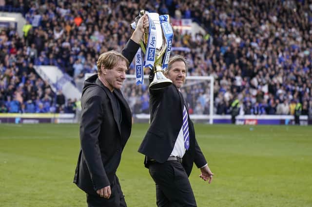 Eric and Breck Eisner celebrate with the League One trophy following Pompey's promotion success. Picture: Jason Brown/ProSportsImages