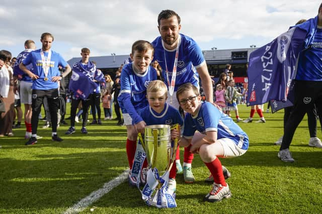 Joe Rafferty and his children celebrate Pompey's League One title success. Picture: Jason Brown/ProSportsImages