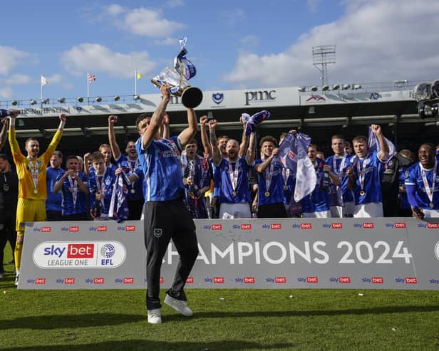 Manchester City's Pompey loanee Alex Robertson lifts the League One trophy aloft on Saturday against Wigan Athletic. Pic: Jason Brown.