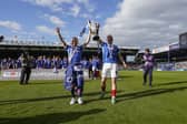 Joe Morrell holds aloft the League One trophy with Colby Bishop at Fratton Park. Picture: Jason Brown/ProSportsImages