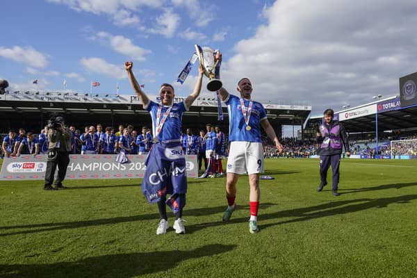 Joe Morrell holds aloft the League One trophy with Colby Bishop at Fratton Park. Picture: Jason Brown/ProSportsImages