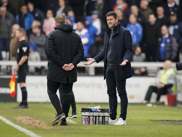 Pompey head coach John Mousinho tries to reason with the fourth official during todays game at Lincoln after referee Sunny Sukhvir Gill dished out 10 yellows to Pompey players and staff