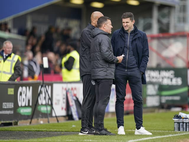 Pompey head coach John Mousinho, right, with Jon Harley and Zesh Rehman