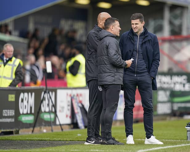 Pompey head coach John Mousinho, right, with Jon Harley and Zesh Rehman