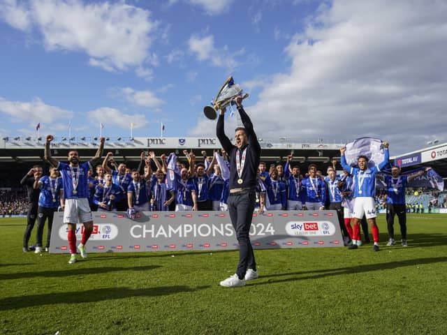 John Mousinho holds aloft the League One trophy. Picture: Jason Brown/ProSportsImages