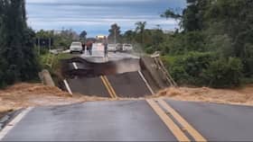 Bridge collapses and plunges into river.