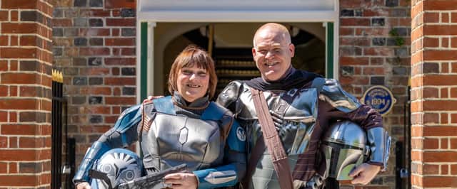 Mandy Rankin, and Dave Rankin in Mandalorian outfits for their Star Wars themed wedding on May The Fourth. 