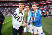 Adam May, right, with Brandon Haunstrup, centre, and Alex Bass, left, after Pompey's Checkatrade Trophy final win against Sunderland in 2019