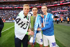 Adam May, right, with Brandon Haunstrup, centre, and Alex Bass, left, after Pompey's Checkatrade Trophy final win against Sunderland in 2019