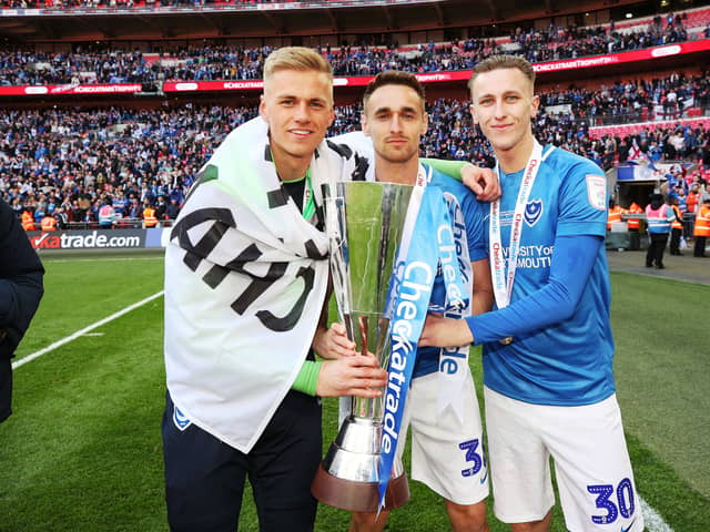Adam May, right, with Brandon Haunstrup, centre, and Alex Bass, left, after Pompey's Checkatrade Trophy final win against Sunderland in 2019
