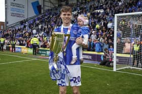 Sean Raggett with daughter Roma celebrate winning the League One title. Picture: Jason Brown/ProSportsImages