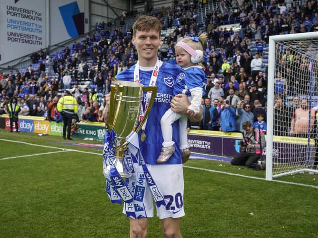 Sean Raggett with daughter Roma celebrate winning the League One title. Picture: Jason Brown/ProSportsImages