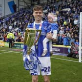 Sean Raggett with daughter Roma celebrate winning the League One title. Picture: Jason Brown/ProSportsImages