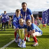 Joe Rafferty and his children celebrate Pompey's League One title success. Picture: Jason Brown/ProSportsImages