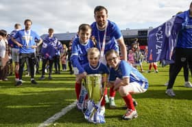 Joe Rafferty and his children celebrate Pompey's League One title success. Picture: Jason Brown/ProSportsImages