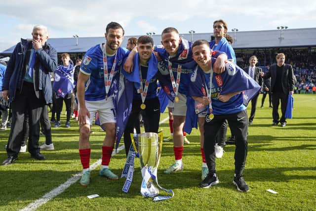 Zak Swanson with Joe Rafferty, Colby Bishop and Tom Lowery after Pompey were crowned League One champions in April 2024. Picture: Jason Brown/ProSportsImages