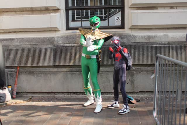 Hundreds of people have turned out this morning to get a glimpse of the action at Comic Con. 
Pictured: Sam Thomas with his nephew Leo. 