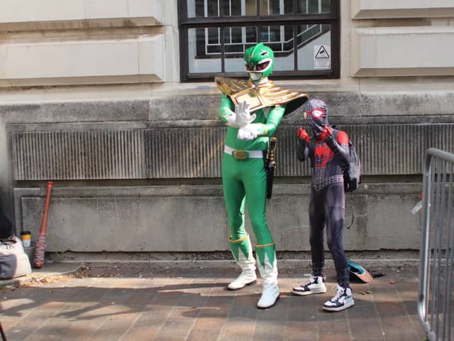 Hundreds of people have turned out this morning to get a glimpse of the action at Comic Con. 
Pictured: Sam Thomas with his nephew Leo. 