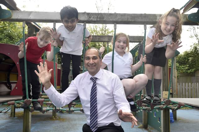 Portsdown Primary School in Cosham, has retained a Good Ofsted report.Pictured is: (middle) Headteacher Ash Vaghela with (l-r) Teddy Wright (7), Kasinadh Lineesh (7), Melody Taylor (8) and Bridie Hayward (7).Picture: Sarah Standing (070524-1939)