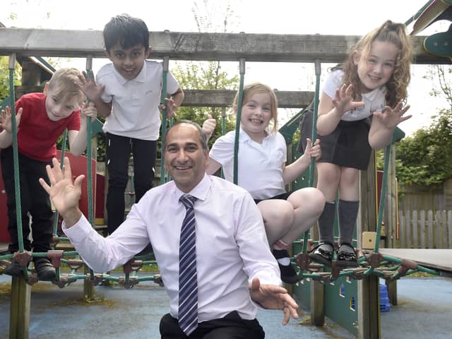 Portsdown Primary School in Cosham, has retained a Good Ofsted report.Pictured is: (middle) Headteacher Ash Vaghela with (l-r) Teddy Wright (7), Kasinadh Lineesh (7), Melody Taylor (8) and Bridie Hayward (7).Picture: Sarah Standing (070524-1939)