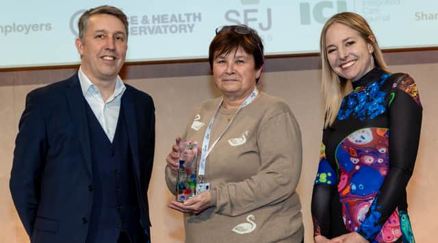 Tina Jackson collects her Our Health Heroes Award from Michael Brodie, chief executive of NHS Business Services Authority, and ceremony host Alice Roberts.