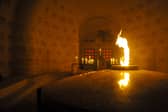 The "Eternal Flame" at the Douaumont boneyard (Ossuaire de Douaumont) on November 10, 2015, in Douaumont, eastern France, on the eve of the Armistice Day. The flame is being brought to Portsmouth as part of a journey to the USA for the 80th anniversary of D-Day. Picture: JEAN-CHRISTOPHE VERHAEGEN/AFP via Getty Images.
