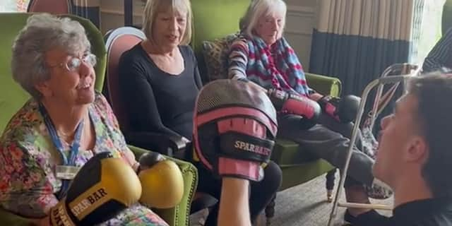 Bailey-Greetham Clark teaches boxing to care home residents.