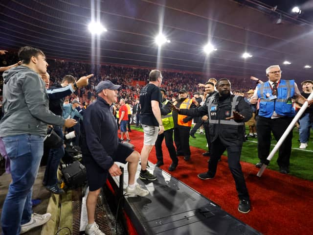 Police and ground staff attempt to separate the Southampton fans from the West Bromwich Albion away stand after the final whistle in the Sky Bet Championship play-off, semi-final, second leg match at St Mary's Stadium, Southampton. Picture date: Friday May 17, 2024. PA Photo. See PA story SOCCER Southampton