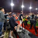 Police and ground staff attempt to separate the Southampton fans from the West Bromwich Albion away stand after the final whistle in the Sky Bet Championship play-off, semi-final, second leg match at St Mary's Stadium, Southampton. Picture date: Friday May 17, 2024. PA Photo. See PA story SOCCER Southampton