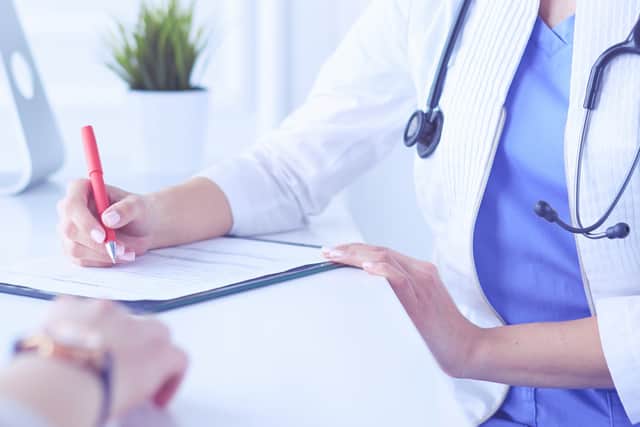 A doctor seeing a patient (Adobe)
