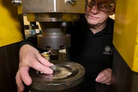 A D-Day 80th anniversary 50p coin in production. Designed by David Lawrence and supported by the experts at the Imperial War Museums, the design portrays Allied soldiers landing in Normandy. Picture: Royal Mint/PA Wire.