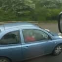 Woman applies make-up while driving along the motorway.