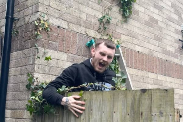 Amusing moment Tyla Shellard, 21, falls from an ivy branch whilst helping to clear a friends garden in Cardiff ready for summer, May 21 2024. 