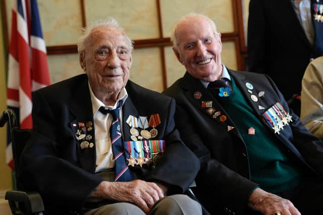 Normandy veterans pose for a photograph in the Map room at Southwick House