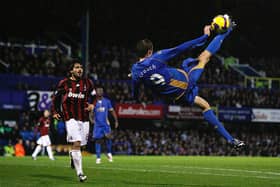 Peter Crouch attempts an overhead kick as he is watched on by AC Milan's Gennaro Gattuso