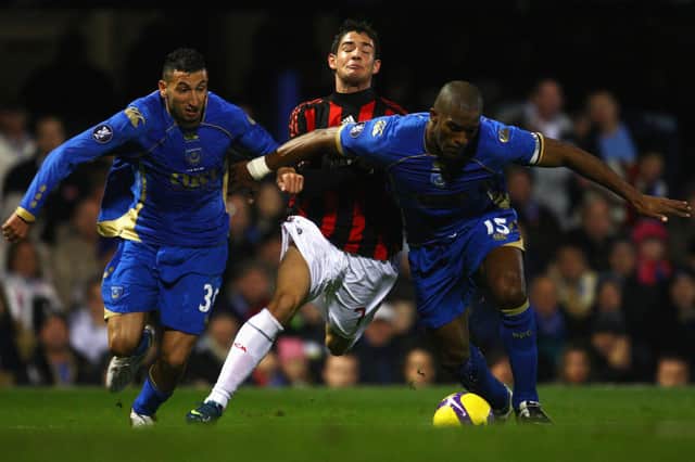 AC Milan's Pato tries to breakthrough Pompey's Sylvain Distin (R) and Nadir Belhadj