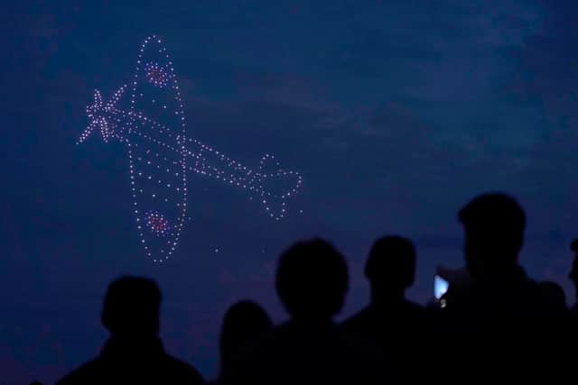 Drones make a Spitfire during a drone display telling the story of D-Day above the coastline in Southsea