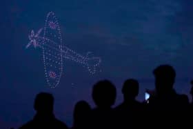 Drones make a Spitfire during a drone display telling the story of D-Day above the coastline in Southsea