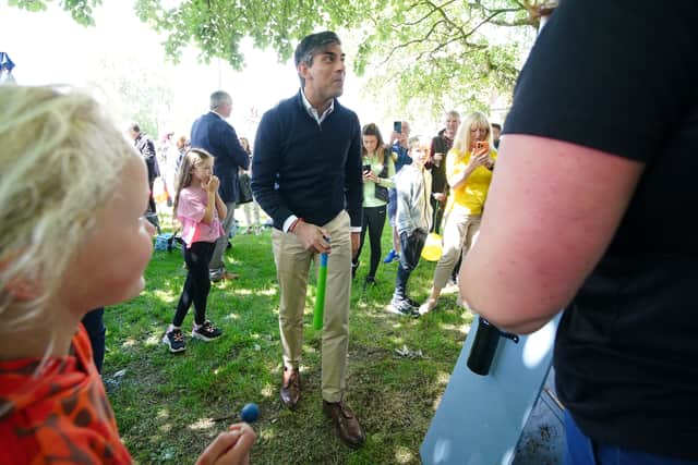 Prime Minister Rishi Sunak talking to a person at a village fete in Great Ayton, Yorkshire while on the General Election campaign trail. The fallout from his D-Day decision has continued. Picture: Peter Byrne/PA Wire