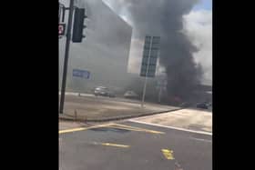 Thick plumes of black smoke covered the area after the car caught fire -Credit:Rick Bache/Facebook