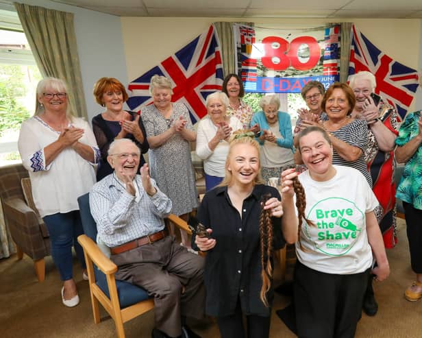 Hannah Bentley had her head shaved for MacMillan, in Glamis Court, Stubbington. Ms Bentley is pictured with professional hairdresser Samantha Hughes, front left, and residents
Picture: Chris  Moorhouse (120624-10)