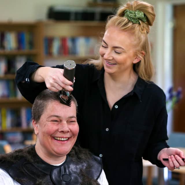 Hairdresser Samantha Hughes shaves Hannah Bentley's hair off for MacMillan Cancer Support.