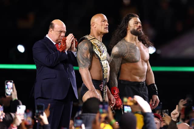 Paul Heyman, Dwayne "The Rock" Johnson and Roman Reigns look on following a fight against Cody Rhodes and Seth "Freakin" Rollins during Night One of WrestleMania 40 at Lincoln Financial Field on April 06, 2024 in Philadelphia, Pennsylvania. (Photo by Tim Nwachukwu/Getty Images)