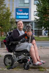 Karen Bishop, 51, with her 2-year-old French bull dog Drew outside the Travelodge in Norwich.