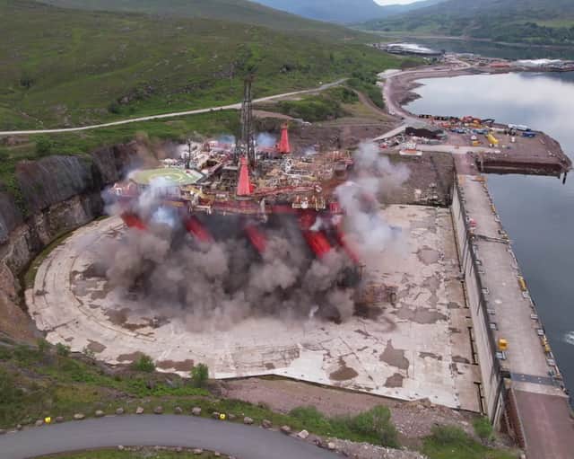 Striking footage shows a decommissioned oil rig being demolished with a controlled explosion. 