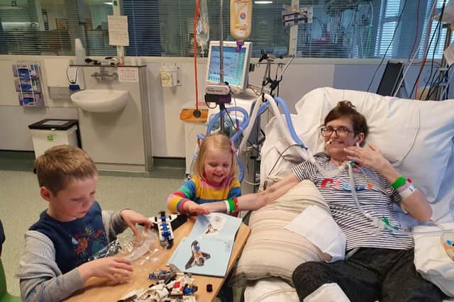Charlotte Ralph in hospital, with her children Ben and Kezia Picture from Cancer Research UK 