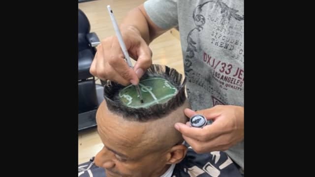A hair artist created a miniature football stadium on a client's head.