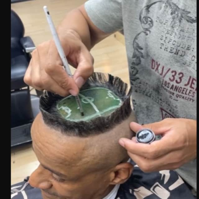 A hair artist created a miniature football stadium on a client's head.