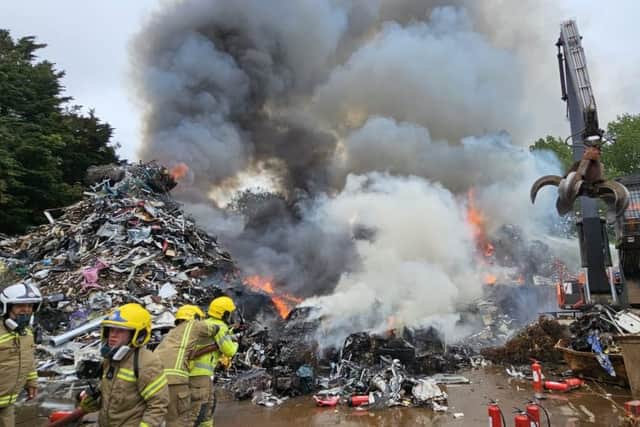 Firefighters tackling a blaze at a scrap yard in Buriton near Petersfield yesterday (July 1). Picture: HIWFRS