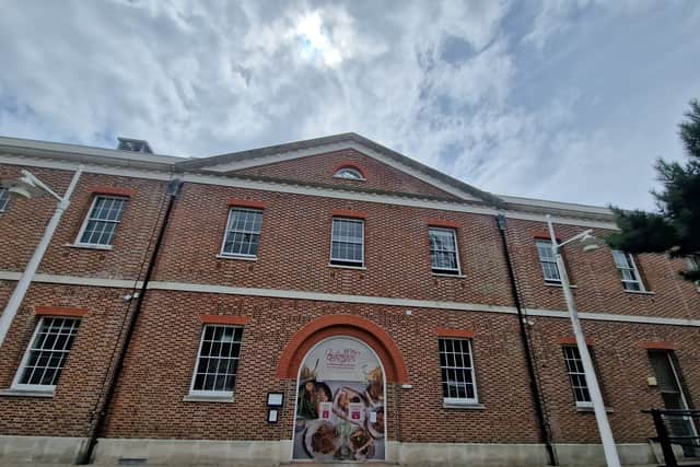 Temporary signage adorns the doors of the iconic Vulcan building in Gunwharf Quays as the site is being transformed into a home for the Giggling Squid which will open this month. 